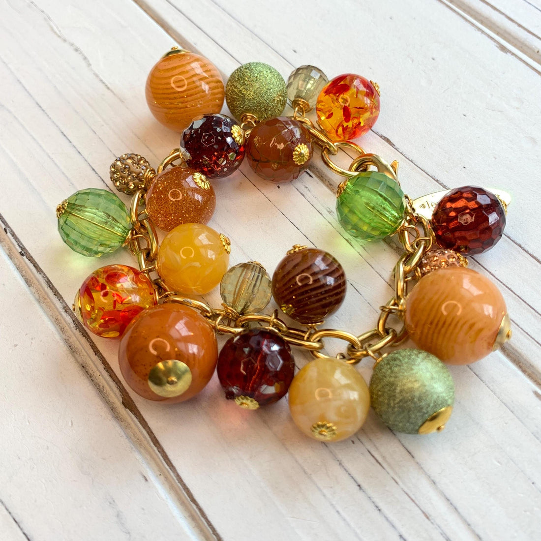 Beaded bracelet in fall colors for women. Orange chunky charm bracelet for women.