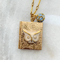 Gold book locket necklace with owl detail on a gold chain. Gold photo locket for women.