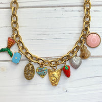 Trendy gold chain charm necklace with a mix of small charms. Vintage charms on a gold chain necklace for women.