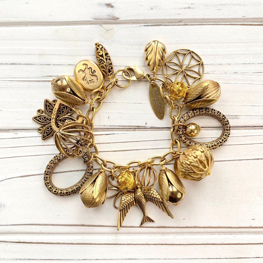 Gold charm bracelet with lots of different gold charms. Charm bracelets for women.