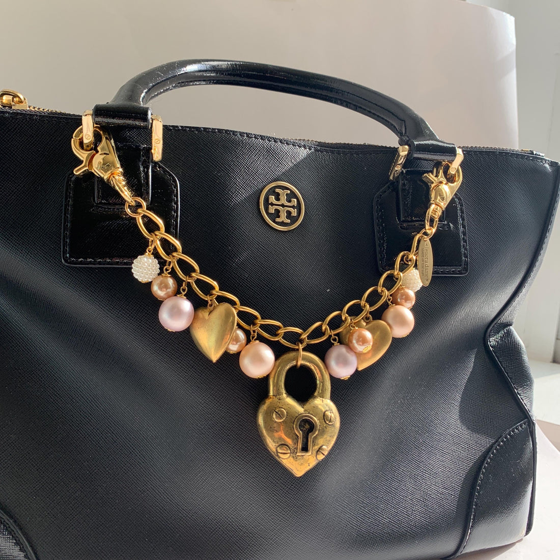 Gold chain bag charm with dangling gold hearts. Valentine&