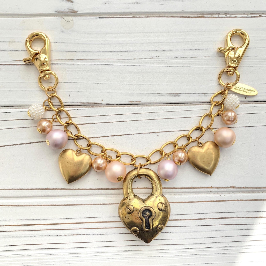 Gold chain bag charm with dangling gold hearts. Valentine&