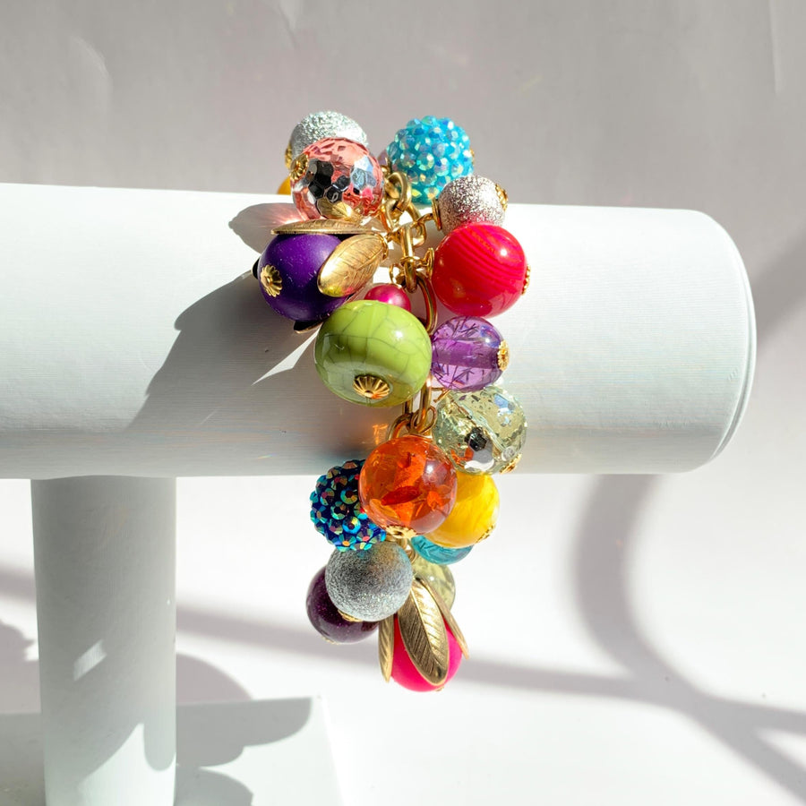 Colorful beaded bracelet for women. Assorted unique beads in a wide range for colors, texture, and shape wire wrapped on a solid and sturdy brass plated chain with lobster clasp.