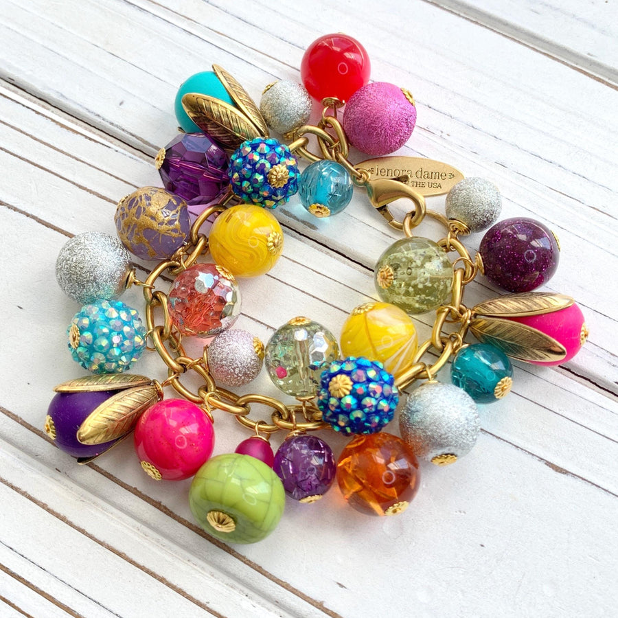 Colorful beaded bracelet for women. Assorted unique beads in a wide range for colors, texture, and shape wire wrapped on a solid and sturdy brass plated chain with lobster clasp.