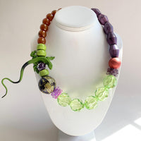 Lizard necklace with green, purple, and brown beads. Purple and green statement necklace for women.