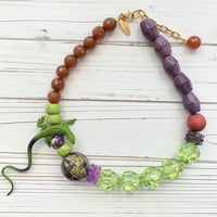 Lizard necklace with green, purple, and brown beads. Purple and green statement necklace for women.