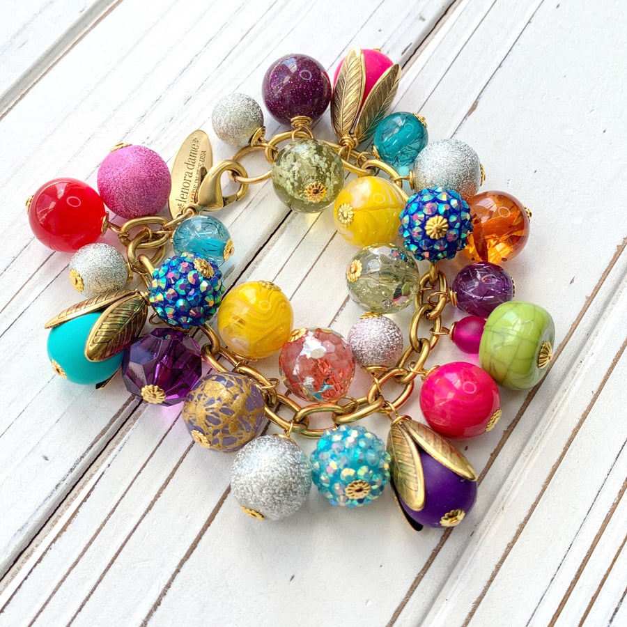 Colorful beaded bracelet for women. Assorted unique beads in a wide range for colors, texture, and shape wire wrapped on a solid and sturdy brass plated chain with lobster clasp.