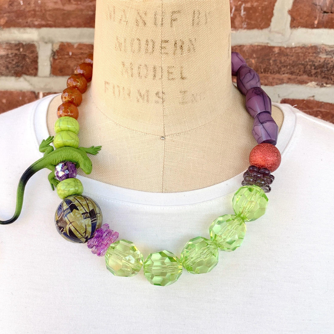 Lizard necklace with green, purple, and brown beads. Purple and green statement necklace for women.